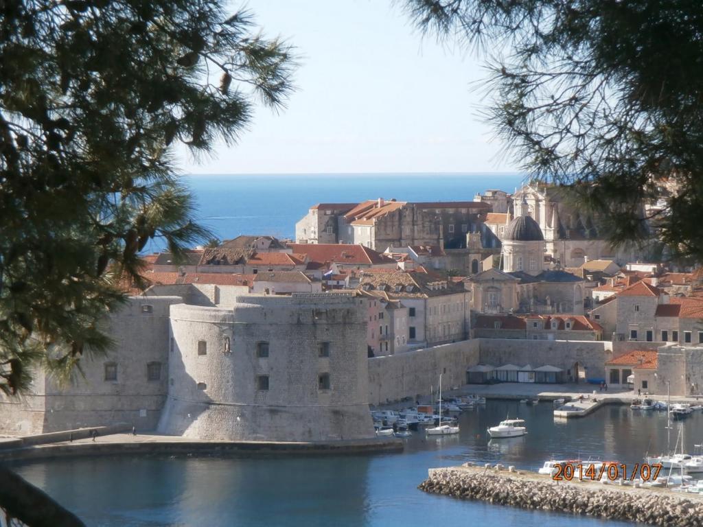 a view of a city with boats in a harbor at Suncana Apartments Dubrovnik in Dubrovnik