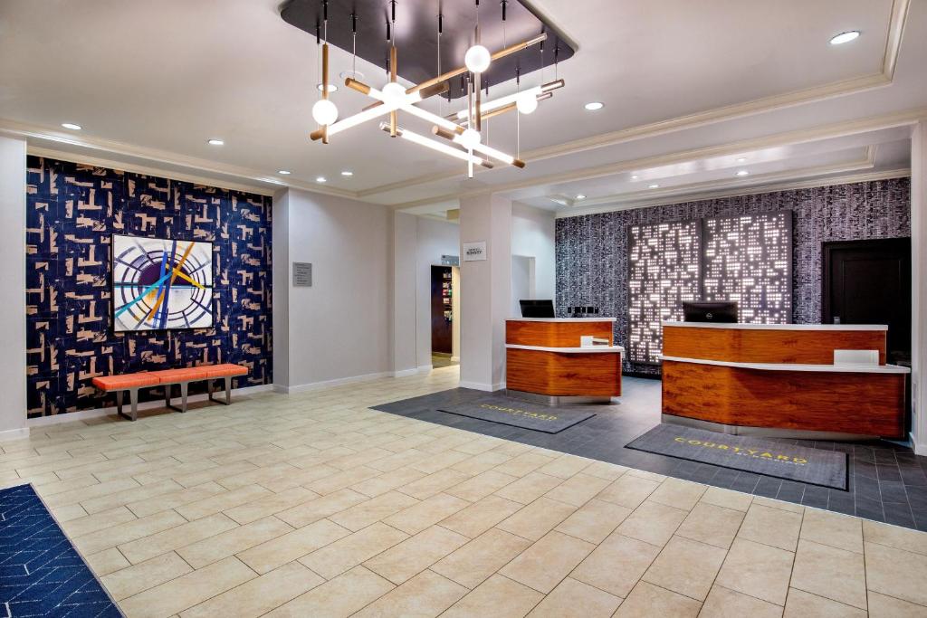 a lobby with two desks and a painting on the wall at Courtyard by Marriott Boston Billerica Bedford in Billerica