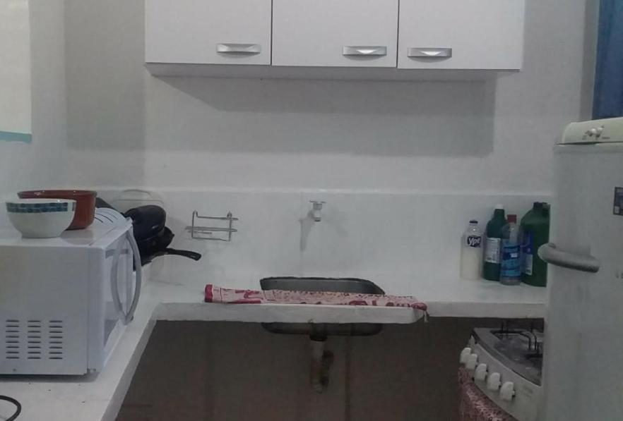 a kitchen with a sink and a microwave at Antonia Hospedaria 4 in Búzios