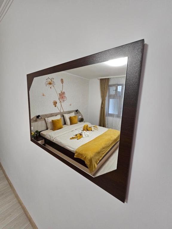 a mirror reflecting a bed in a bedroom at Апартамент за гости Криси гр. Девин in Devin