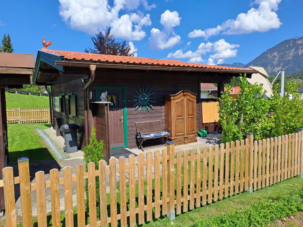 a wooden fence in front of a small house at Chalet Panorama Tirol in Hofen