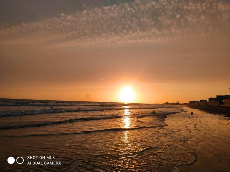 a sunset on a beach with the sun setting at Le Front de Mer, superbe vue mer in Saint-Jean-de-Monts