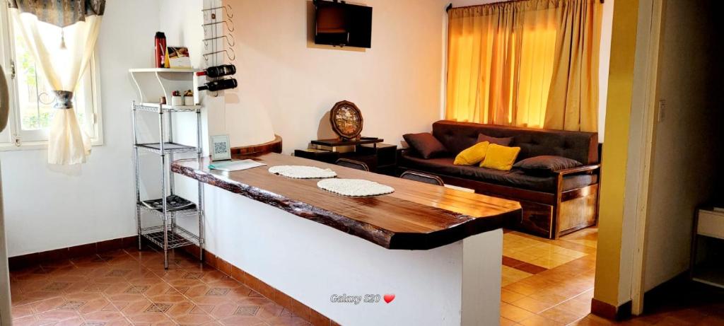 a living room with a table and a couch at CASA ZONA CASINO, SUPERMERCADO. TODAS LAS COMODIDADES in Eldorado