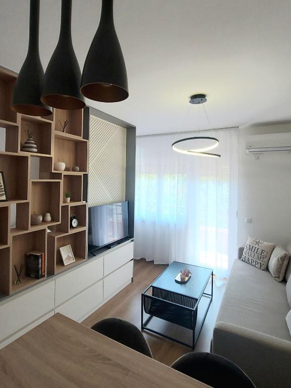 a living room with a couch and a table at Studio apartman Iskra, self check IN-OUT in Županja