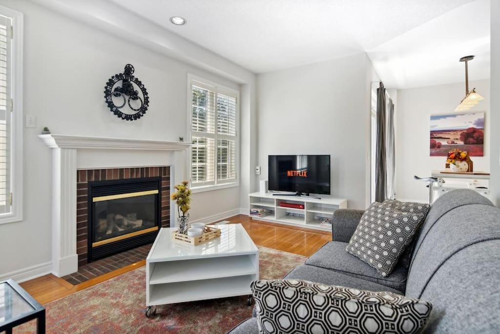 a living room with a couch and a fireplace at The cozy corner House in the Richmond Hill in Richmond Hill