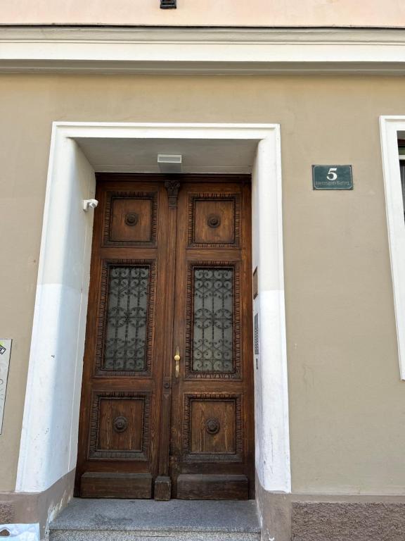 a wooden door in a building with a sign on it at Urban Apartment for Erasmus Student, Zentrum in Graz