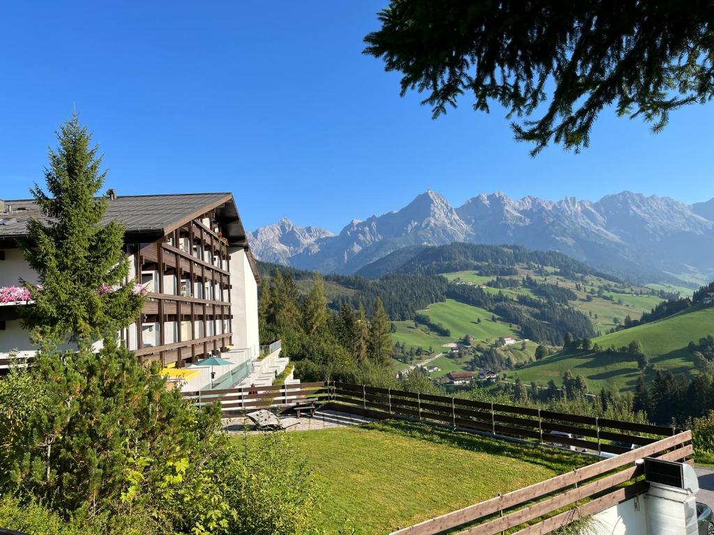 a view of a hotel with mountains in the background at Appartement Malejo am Hochkönig in Bachwinkl