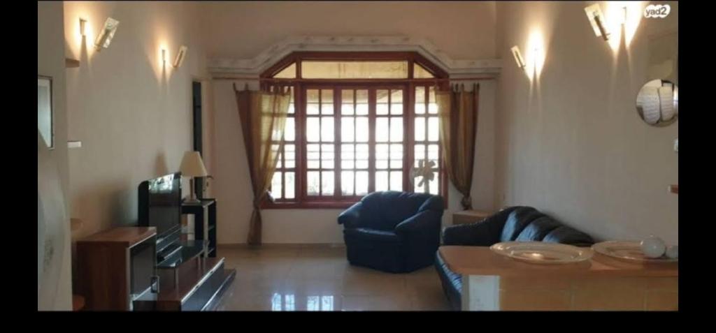 un soggiorno con divano e tavolo di Apartment 4 Rooms נוה שאנן a Haifa