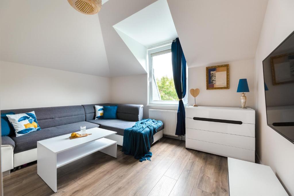 a small living room with a couch and a table at Family Apartment - Centrum in Kudowa-Zdrój