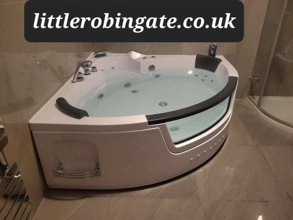 a jacuzzi tub in a bathroom with the wordsibliotechnology cox at Little Robin Gate - Free Parking - Central - 10 min Walk to Train Station in Bournemouth