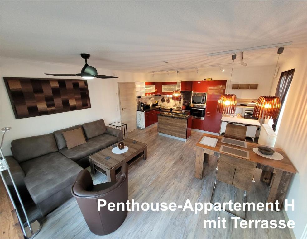 a living room with a couch and a table at Penthouse-Apartment AM KORNFELD in Lünen