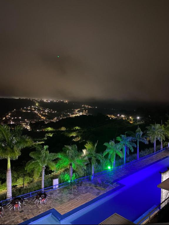 a view of a city at night with palm trees at Apartamento Alto da Serra Villas in Bananeiras