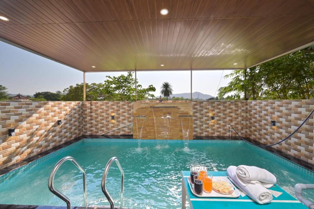 a swimming pool with a table with food on it at shubh villa 4bhk in Lonavala