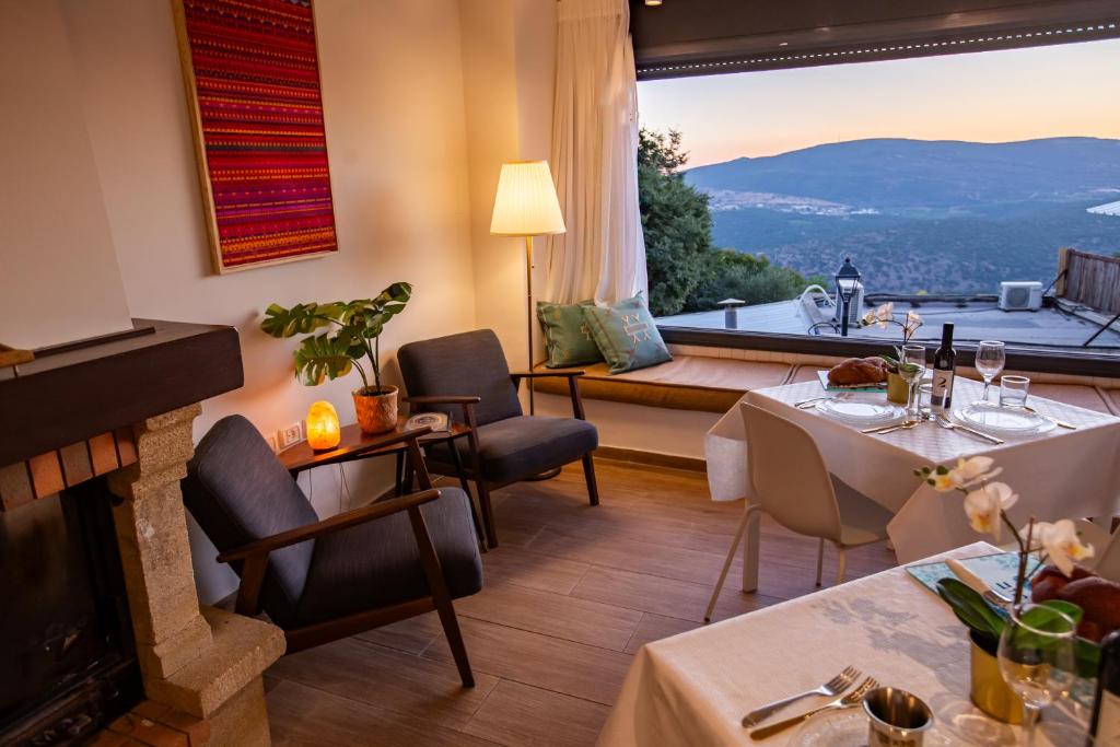 a dining room with a fireplace and a large window at Maim Haim Tzfat - Boutique Suites Prime location Old City Tzfat in Safed