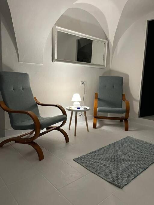 a living room with two chairs and a table at city center Santorín in Banská Bystrica