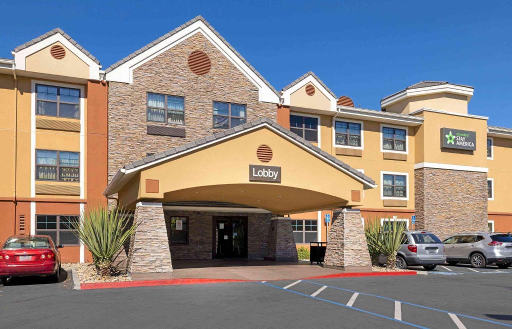 a hotel with cars parked in a parking lot at Extended Stay America Suites - San Diego - Carlsbad Village by the Sea in Carlsbad