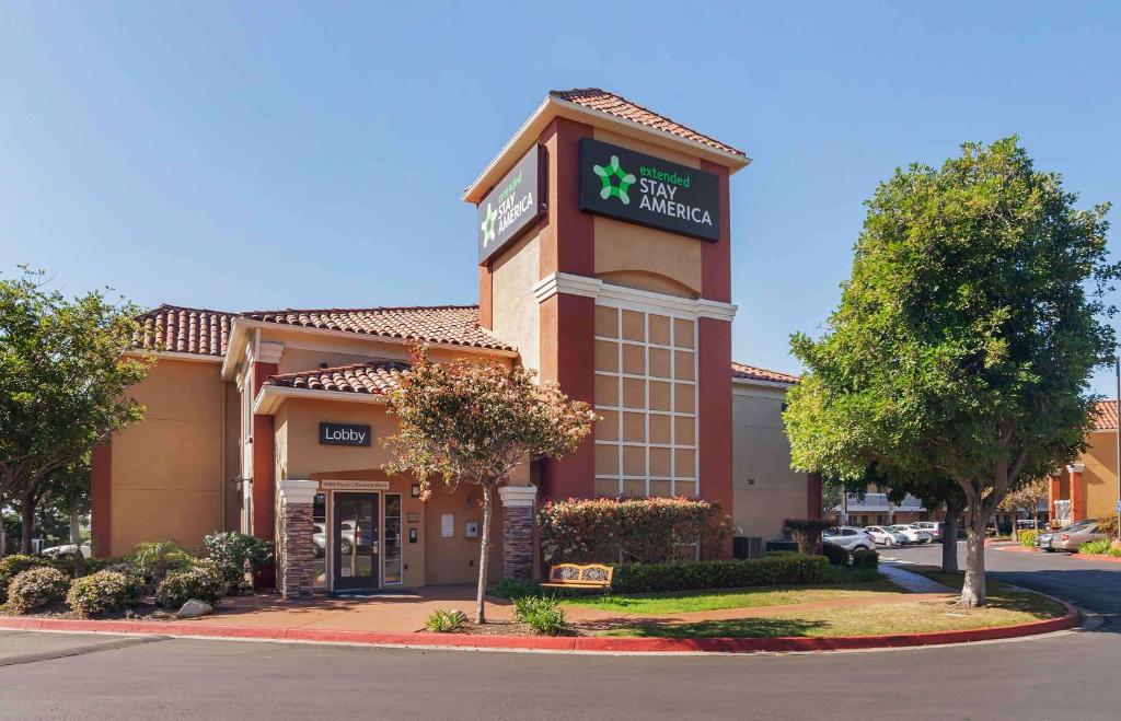 a hotel building with a clock on top of it at Extended Stay America Suites - San Diego - Sorrento Mesa in Sorrento