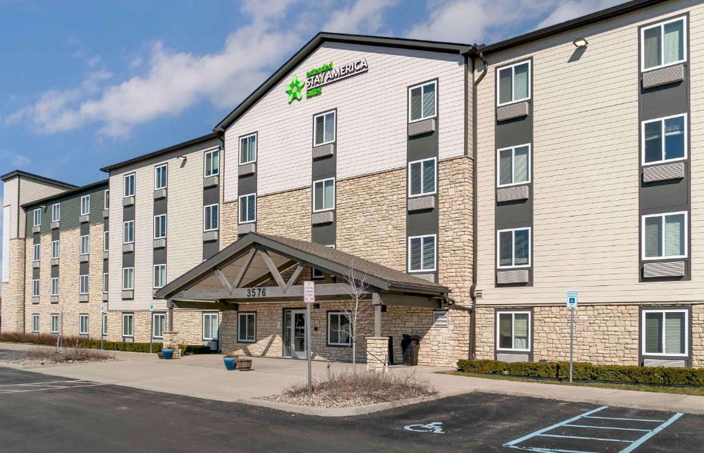 a large building with a sign on the front of it at Extended Stay America Suites - Detroit - Rochester Hills in Rochester Hills