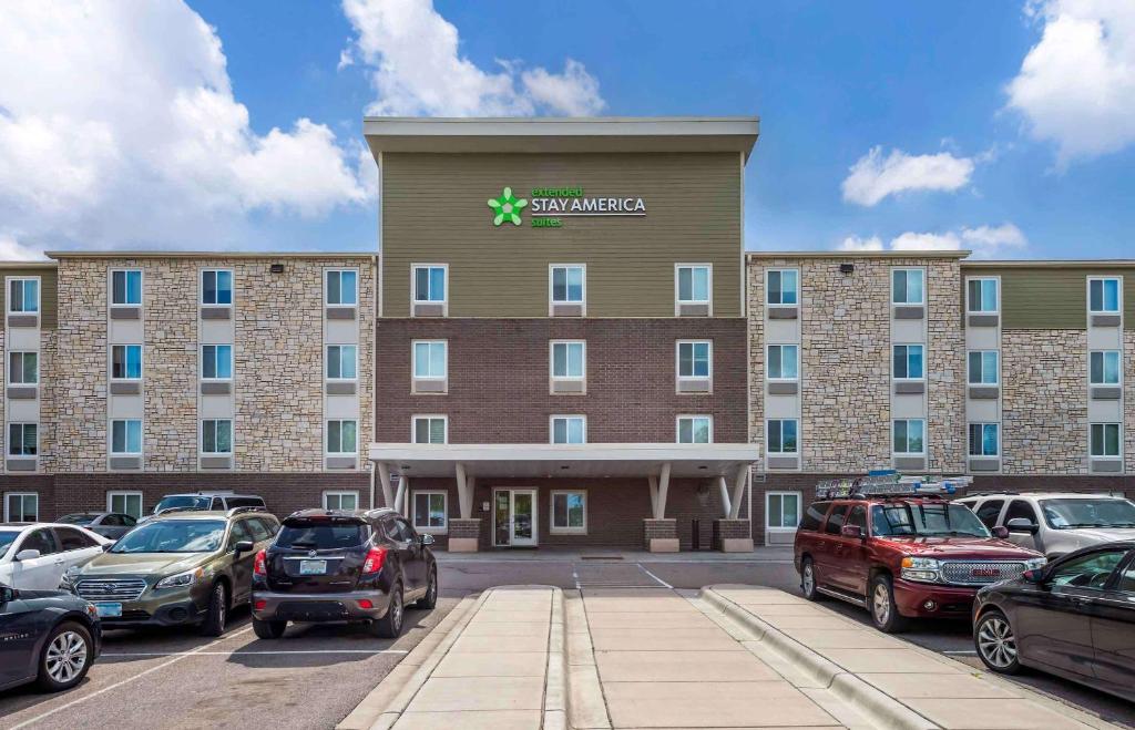 a large building with cars parked in a parking lot at Extended Stay America Suites - St Paul - Woodbury in Woodbury