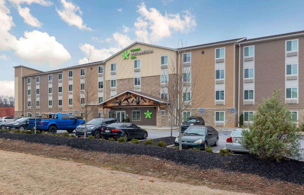 a large building with cars parked in a parking lot at Extended Stay America Suites - Atlanta - Lithia Springs in Lithia Springs