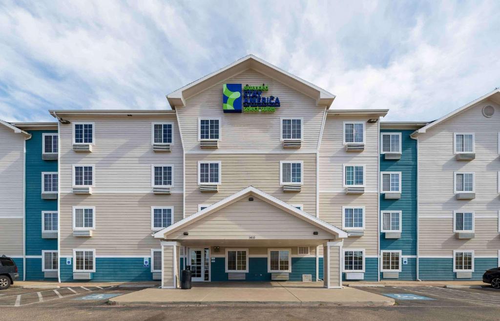 a large apartment building with a sign on it at Extended Stay America Select Suites - Lubbock - South in Lubbock
