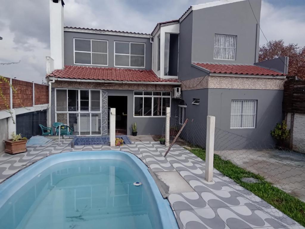 a house with a swimming pool in front of a house at Pousada VIDA in Pelotas