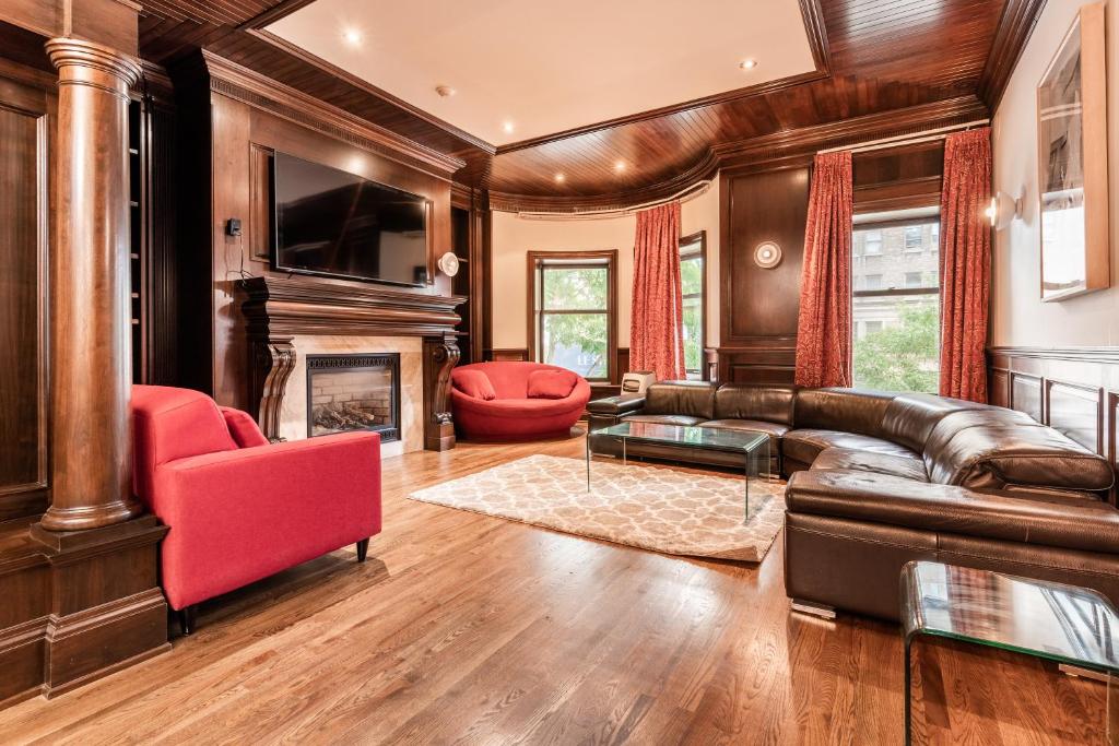 a living room with a leather couch and a fireplace at Superb city center Penthouse on two floors-C in Montreal