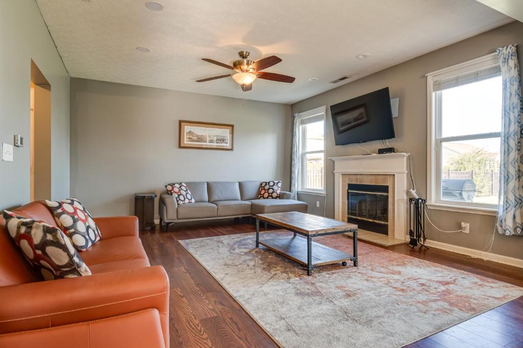 a living room with a couch and a fireplace at Indianapolis Home with Patio and Community Pool! in Indianapolis