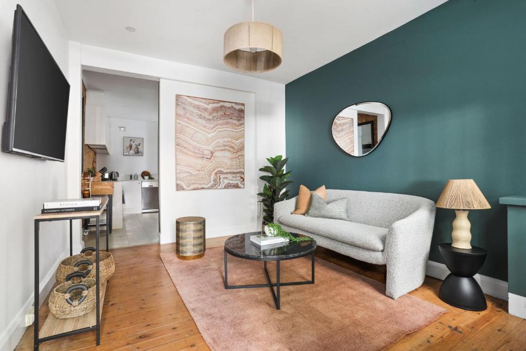 a living room with a couch and a table at Stylish Darlinghurst Townhouse l 3 Bedrooms in Sydney