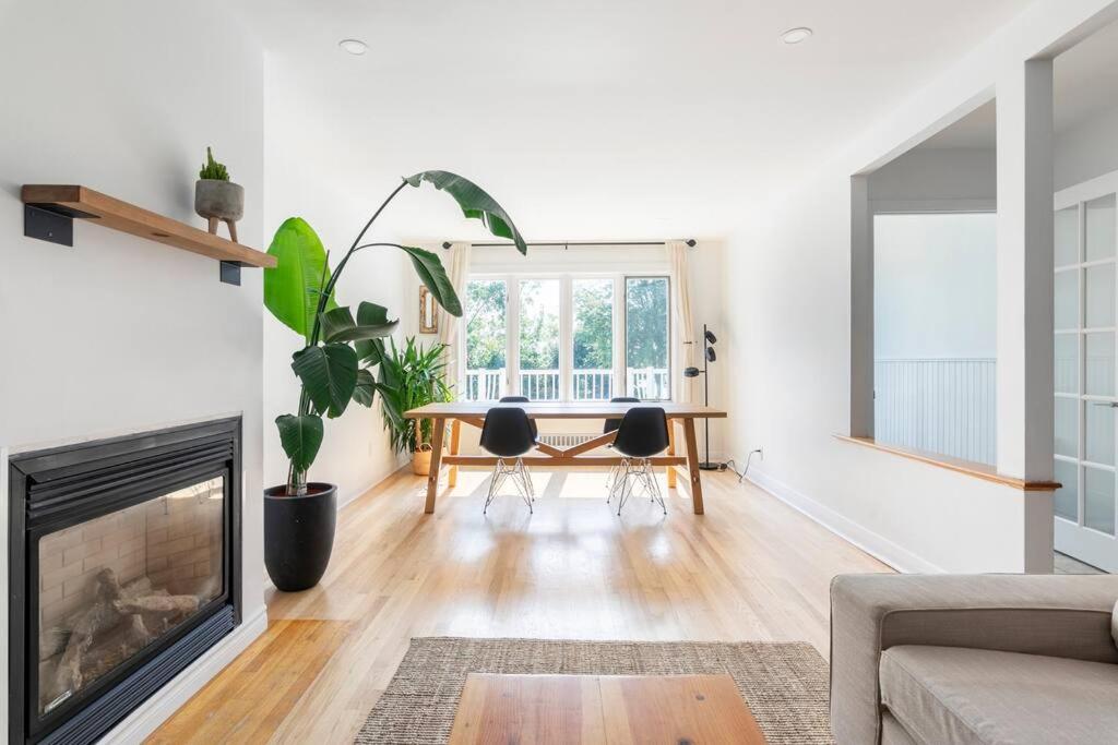 a living room with a fireplace and a table at Bright Riverfront 3-Bedroom Condo in Montreal