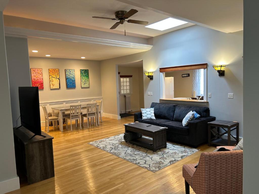 a living room with a couch and a dining room at Spacious Medford Gem in Medford