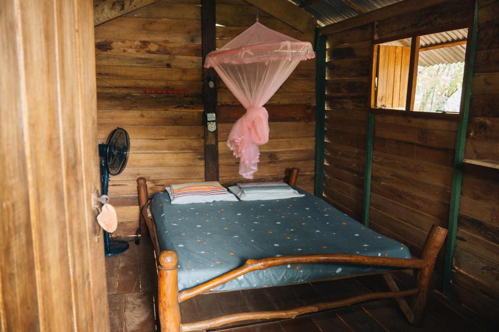 a bedroom with a bed in a log cabin at Angry Birds Tree house in Habarana