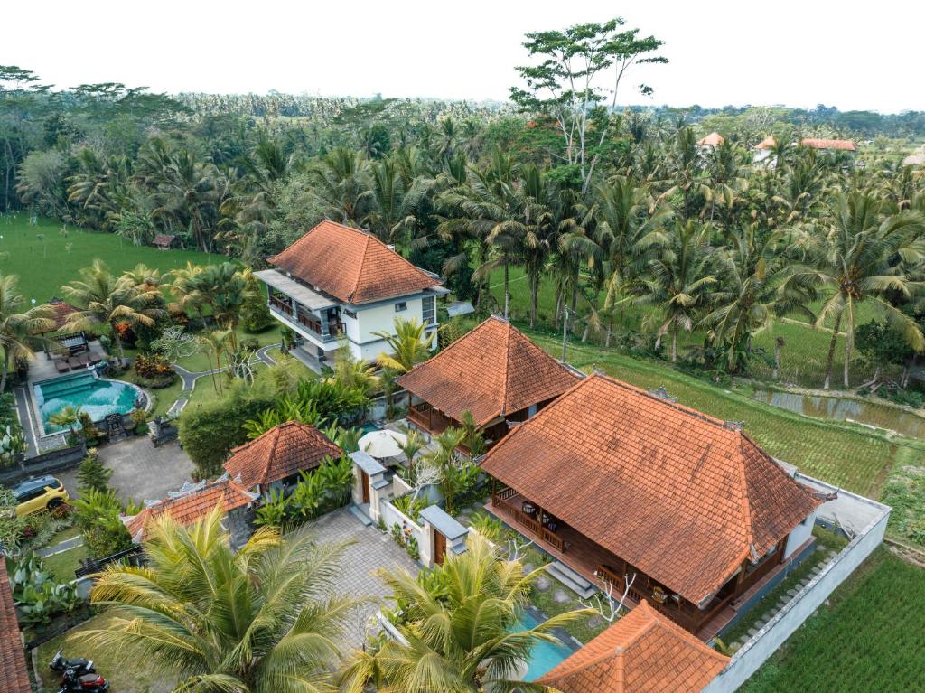 an aerial view of a house with a pool and palm trees at Meng Bengil Villa in Ubud