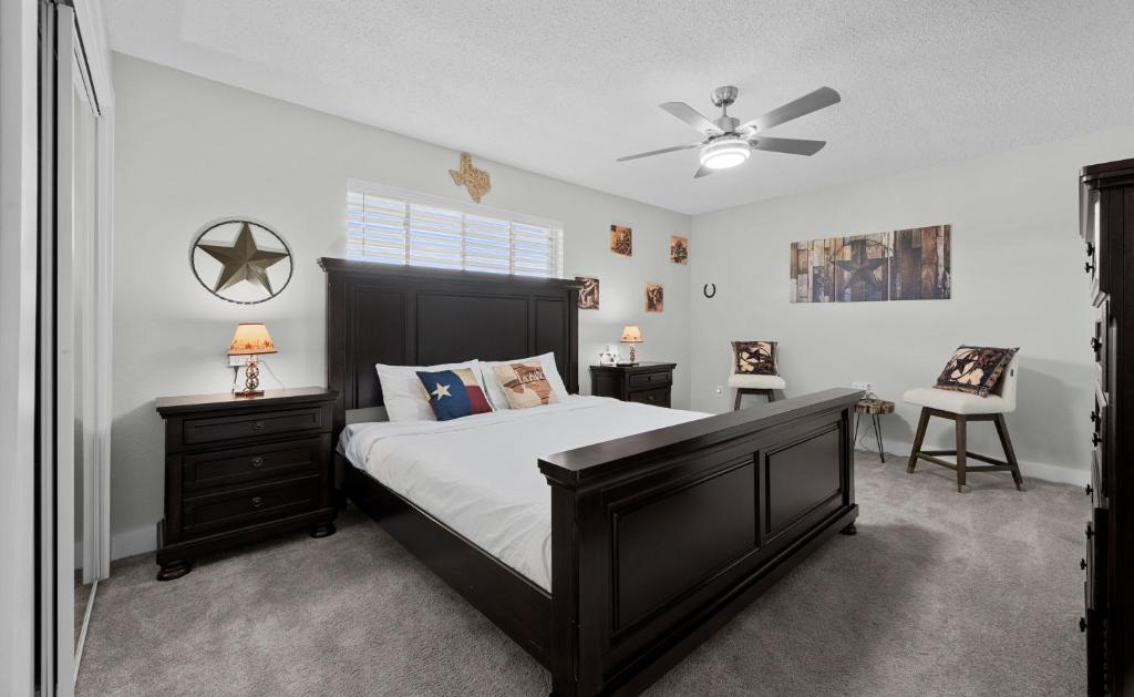 a bedroom with a bed and a ceiling fan at The Texas Pearl in Corpus Christi