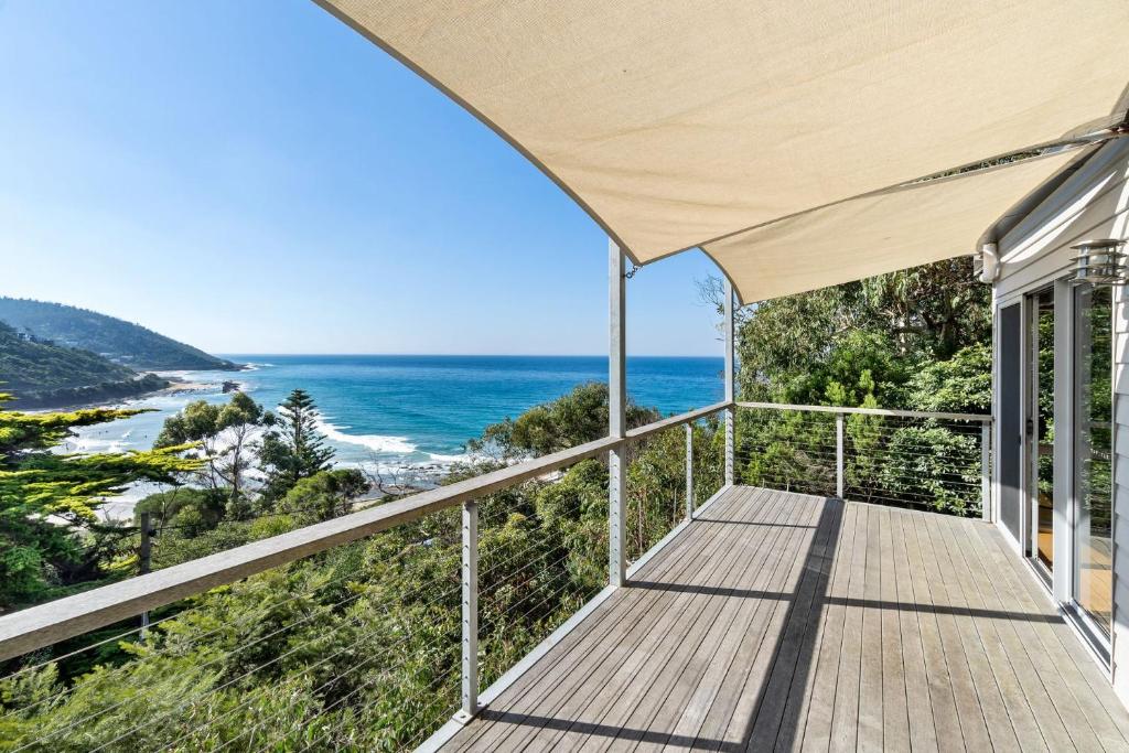 a house with a balcony with a view of the ocean at Altair in Wye River
