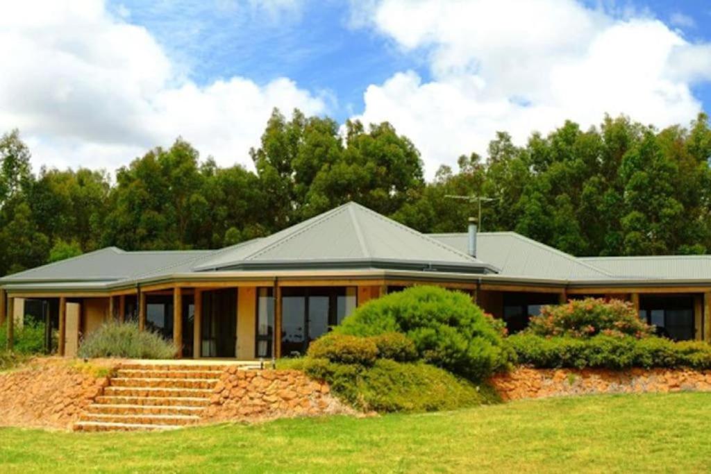 a house with a green roof and some trees at Rural Hideaway - Yallingup in Yallingup