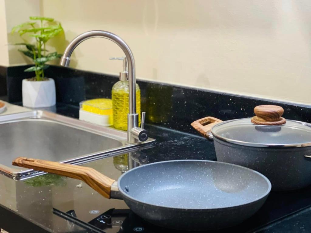 a pan sitting on a stove next to a sink at Richjones Bed & Breakfast in Manila