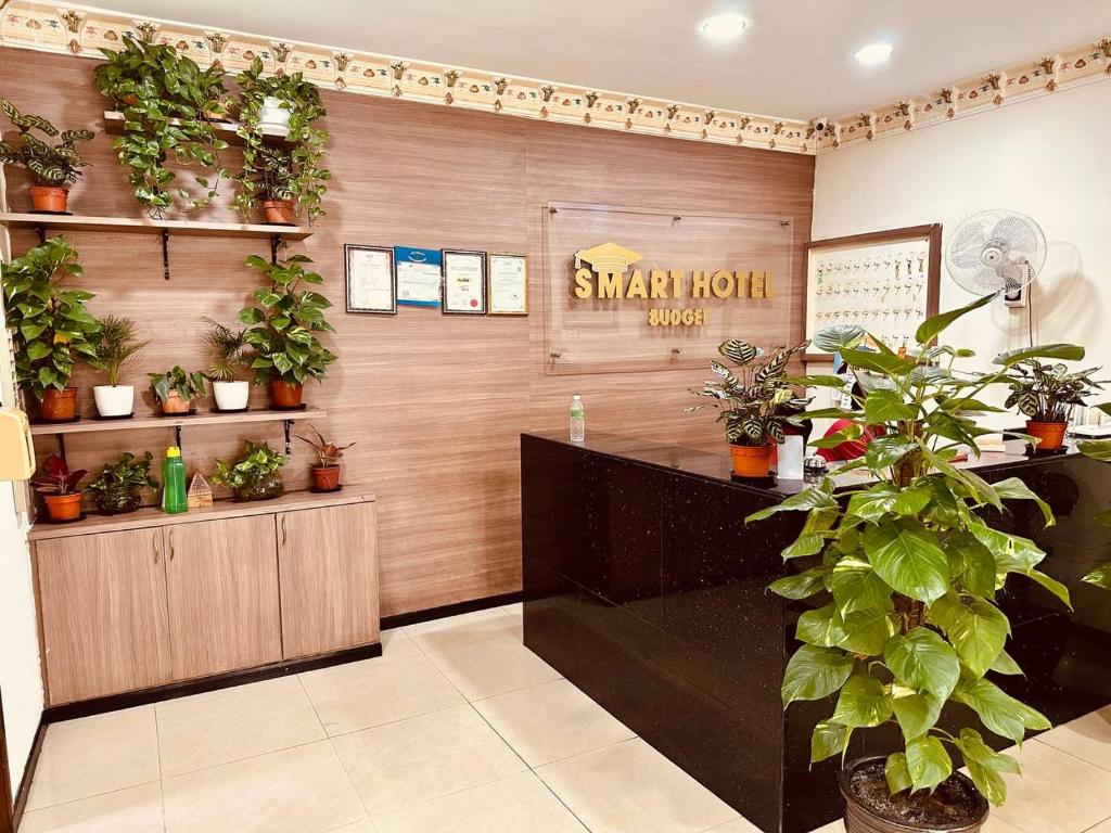 a waiting room with plants on the wall at Smart Budget Hotel - Klang in Klang