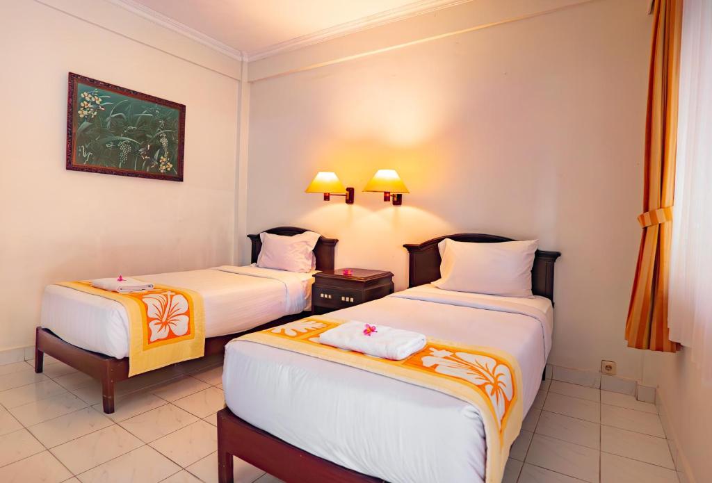 Postel nebo postele na pokoji v ubytování Bali Summer Hotel by Amerta
