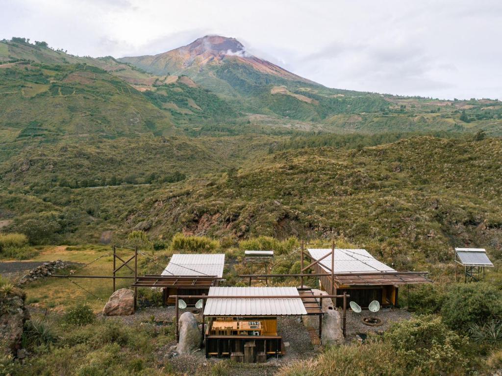 a small house with a mountain in the background at Stunning cabin in Baños in Baños