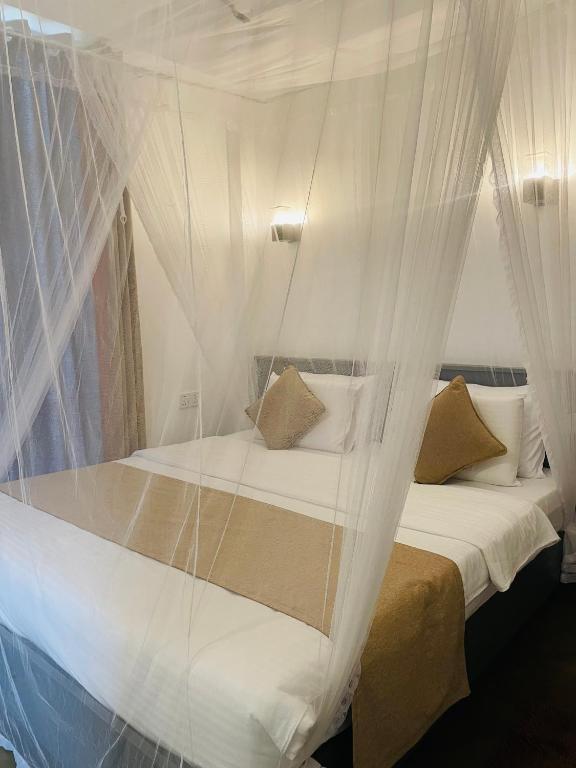 Postel nebo postele na pokoji v ubytování Kithal Ella Station Resort