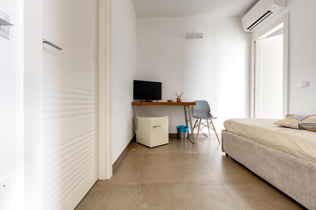 Postel nebo postele na pokoji v ubytování Serafini Rooms