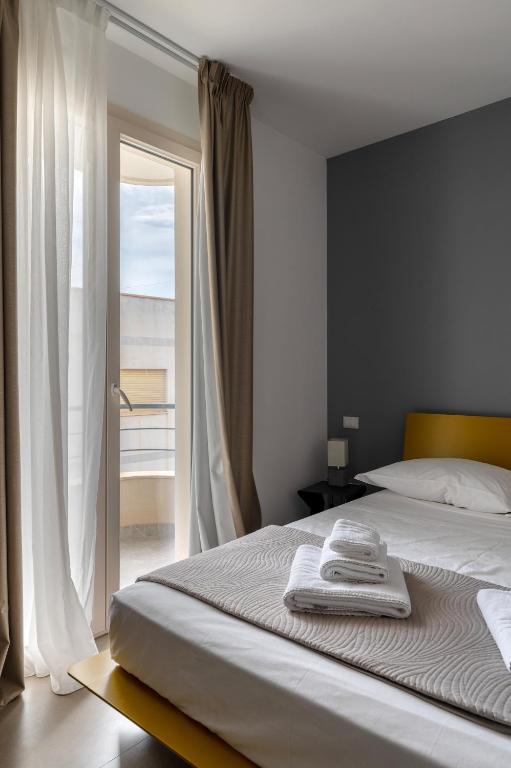 Postel nebo postele na pokoji v ubytování Serafini Rooms