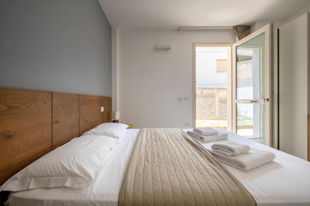 Postel nebo postele na pokoji v ubytování Serafini Rooms