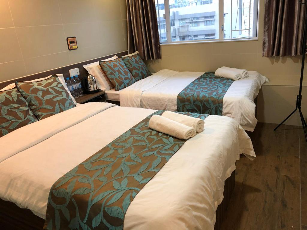 Postel nebo postele na pokoji v ubytování 香港星星旅馆 2202 Guesthouse