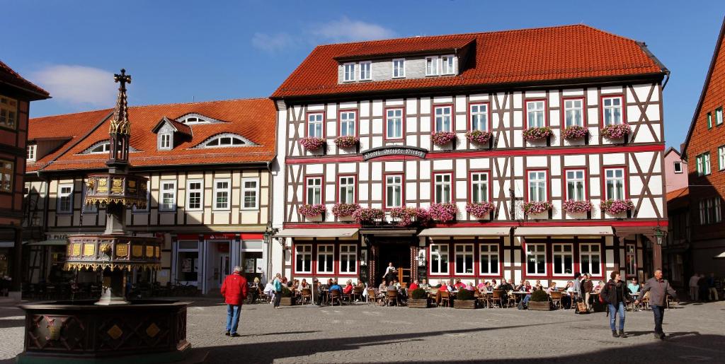 een groot gebouw waar mensen voor lopen bij Ringhotel Weißer Hirsch in Wernigerode