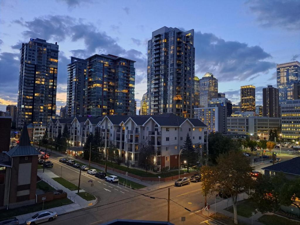 a city skyline at night with tall buildings at Cozy apartment with amazing view in Calgary
