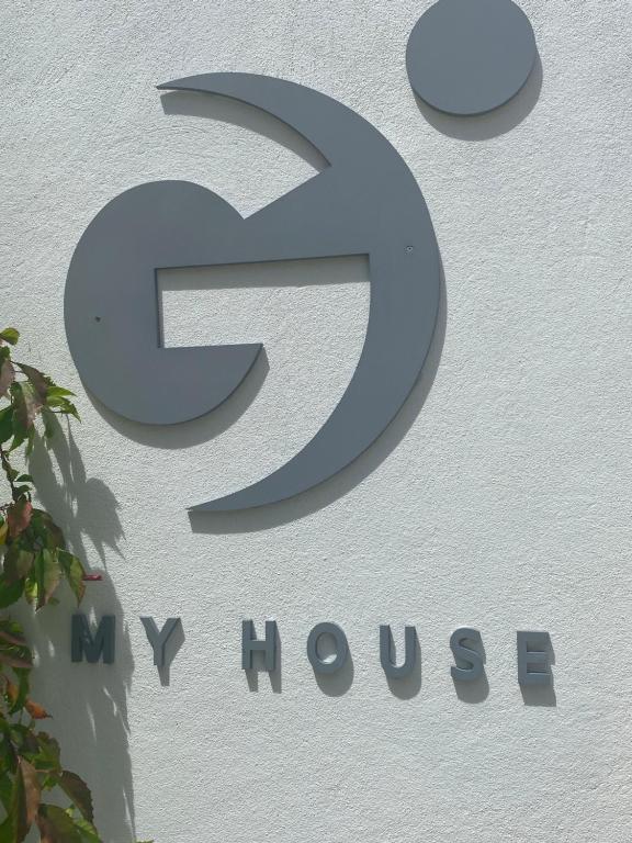 a sign for a new showroom on a building at My House in Vashafaru