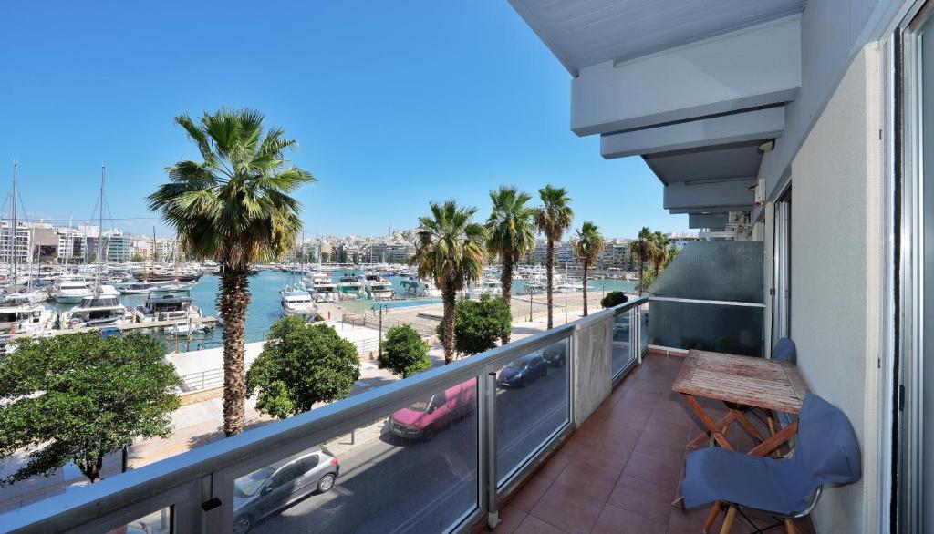 a balcony with a table and a view of a marina at Piraeus yacht view apartment in Piraeus