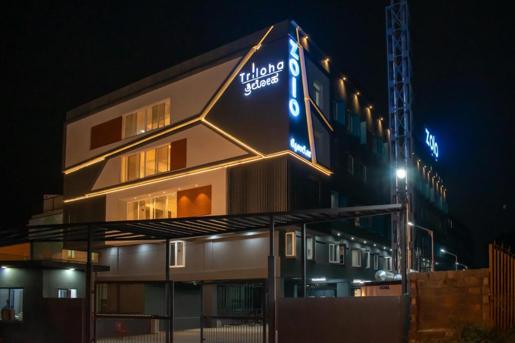 a building with a sign on it at night at U by Z Hotels, Bellandur in Bangalore